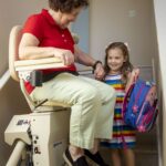 Elderly woman on a stairlift aging in place in the comfort of her own home.