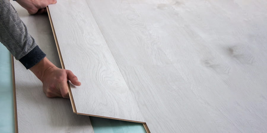 Laminate floor boards being installed