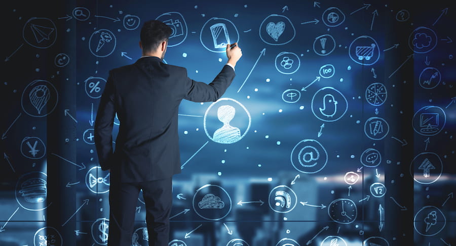 Businessman Drawing Social Media Icons on Glass Wall