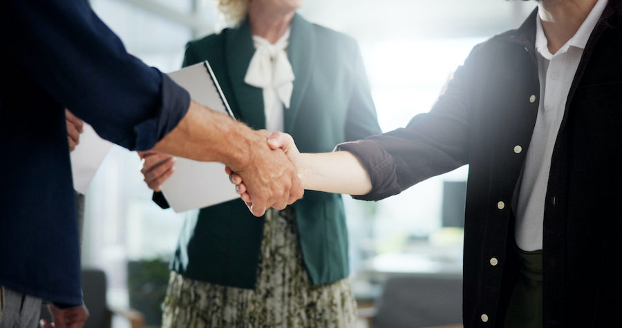 Handshake, deal and business people in office for investment agreement, partnership or meeting. Dis.