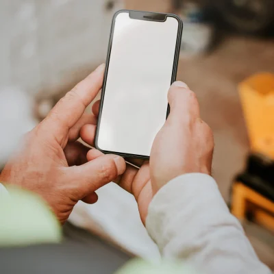 man-holding-blank-smartphone-near-a-construction-s-2022-04-20-22-19-39-utc-scaled